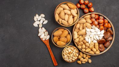 top-view-different-nuts-fresh-nuts-inside-pots-dark-surface